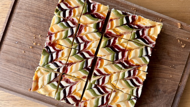 Rainbow cheesecake bars cut into squares