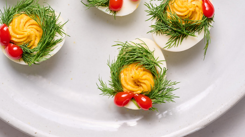 naughty and nice deviled eggs on white plate