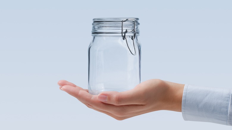 Glass jar in woman's palm