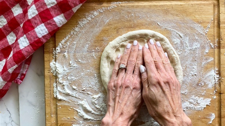 pizza dough with hands 