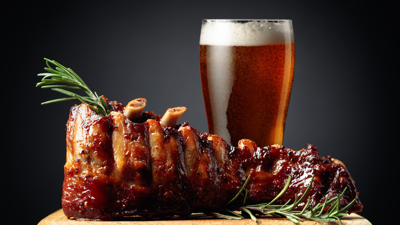 Glass of beer next to barbecued pork ribs