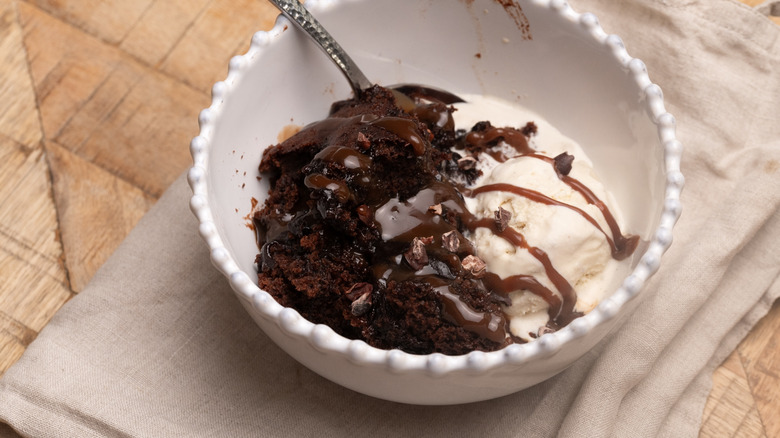 chocolate cobbler in bowl with ice cream
