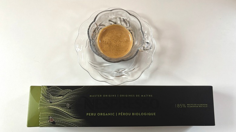 A mug of nespresso Master Origins Peru coffee above a box of pods