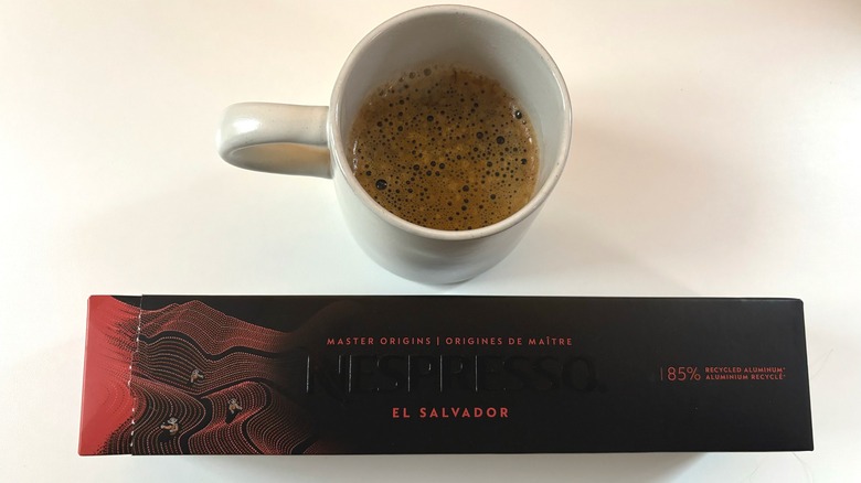 A mug of Nespresso El Salvador coffee above a box of coffee pods