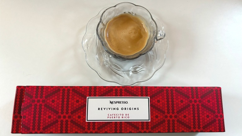 A cup of Nespresso Puerto Rico coffee above a red box of pods