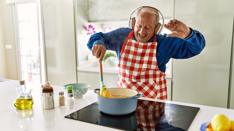 Senior man dancing making pasta