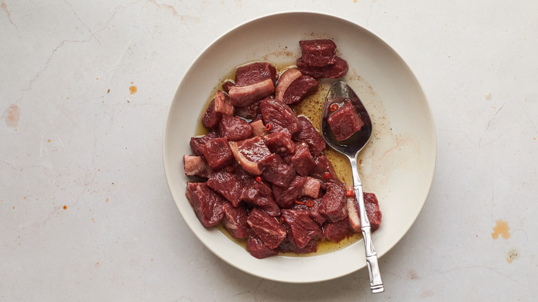 steak tips marinating in bowl