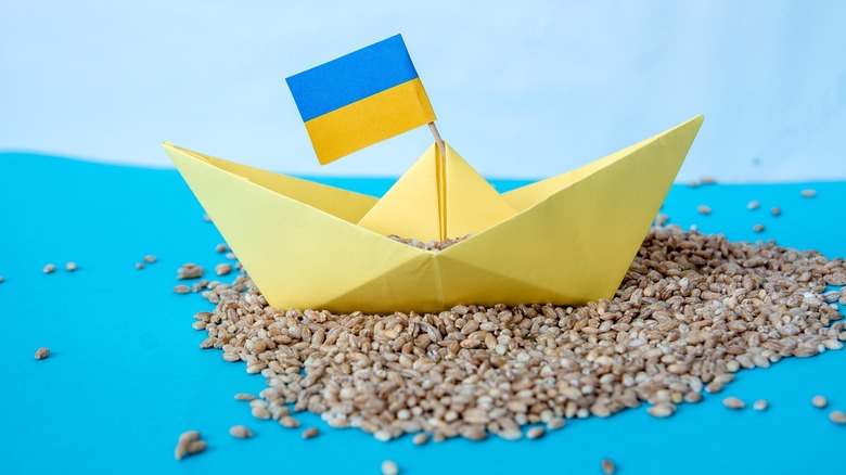 paper Ukrainian ship on a bed of grain