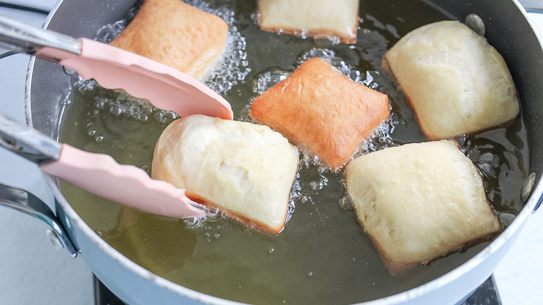 beignets frying in pot