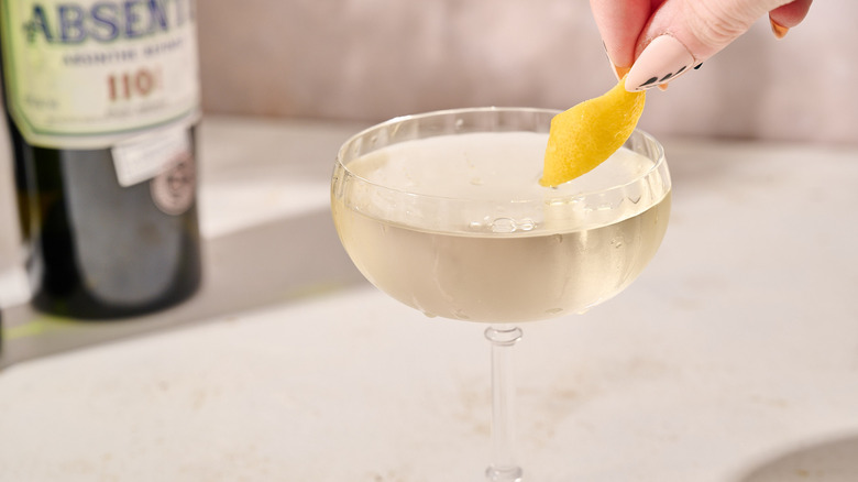 Garnishing martini with lemon