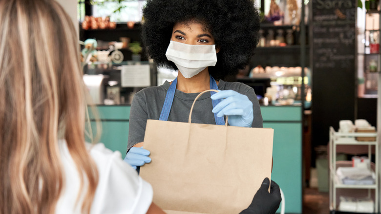 Restaurant worker delivers order 