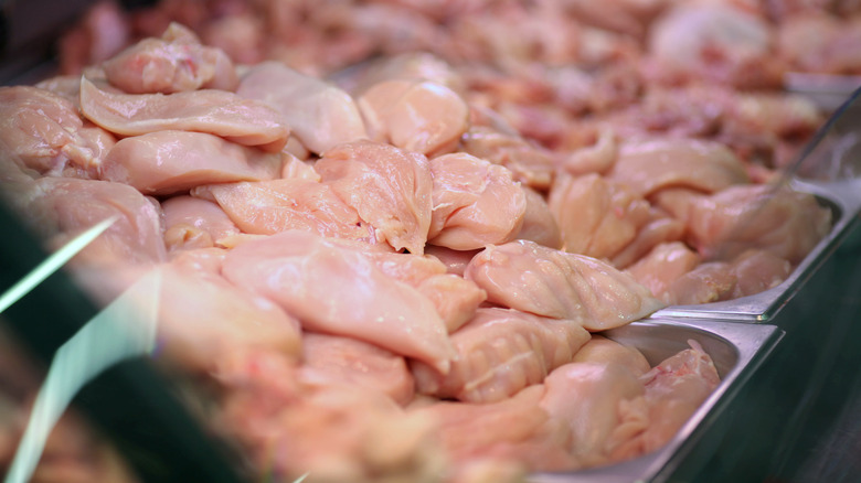 raw chicken in metal containers