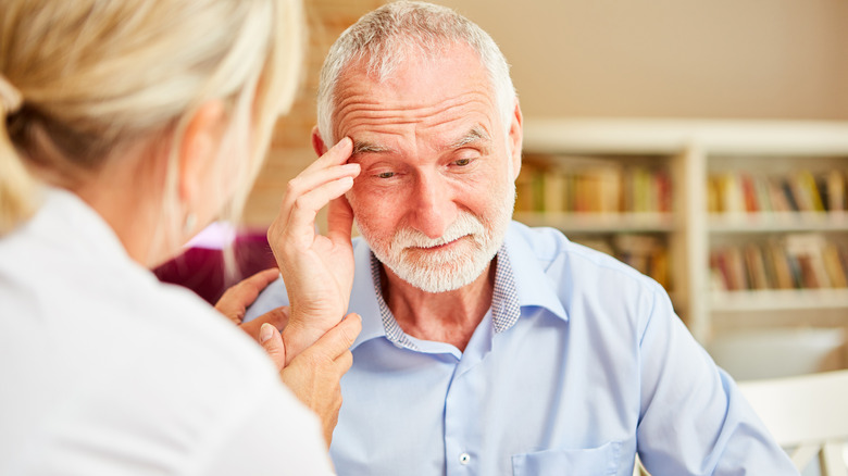 An elderly patient speaking to a doctor 