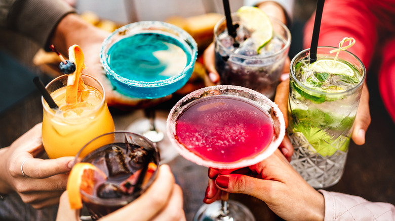 A variety of colorful cocktails at a bar