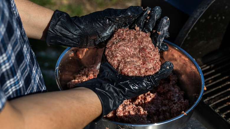 Burger patties going on smoker