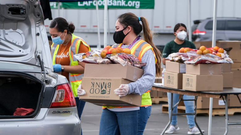 food bank worker loads donation 