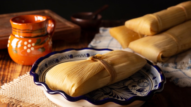 stack of tamales wooden table