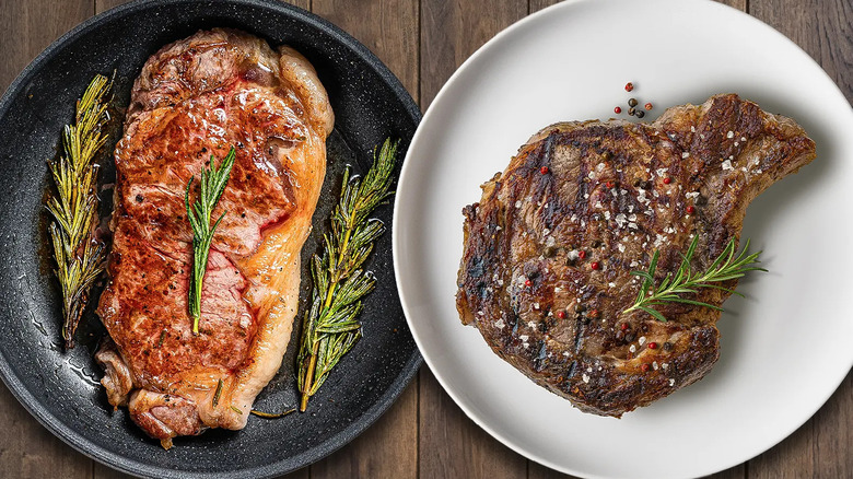 New York strip and ribeye steak side-by-side on plate