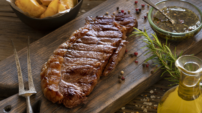 grilled strip steak on cutting board