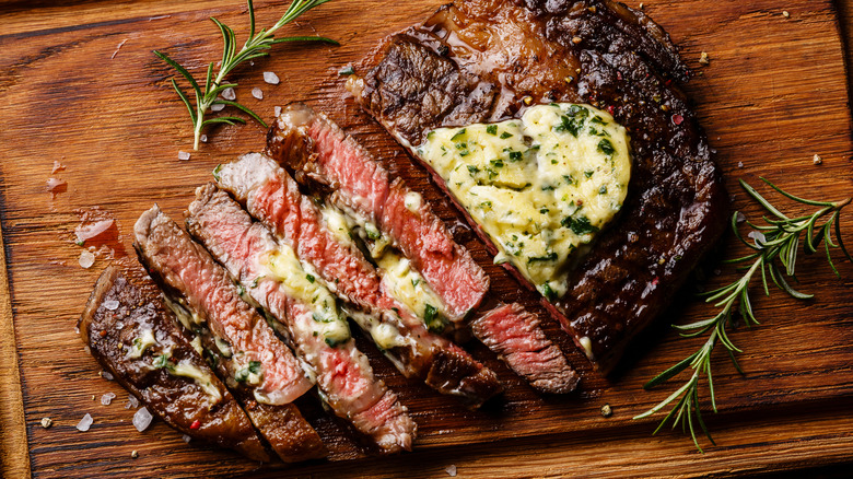 sliced ribeye steak with herb butter