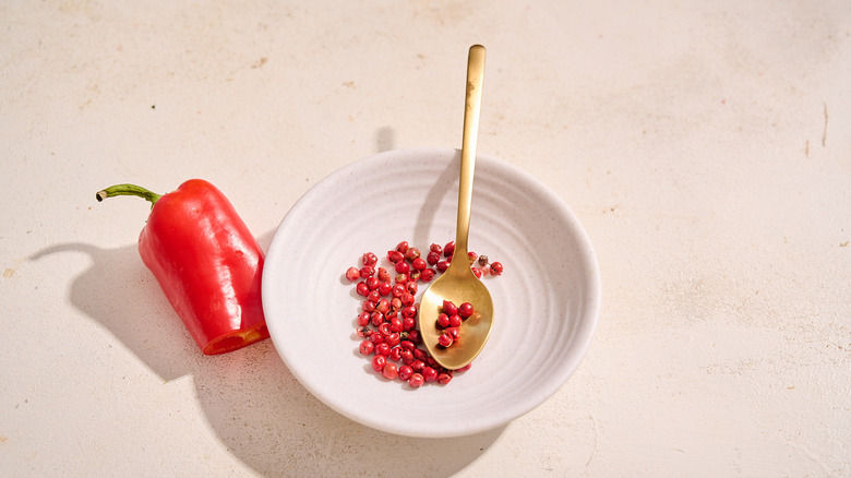 pink peppercorns on small plate