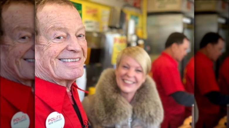 Gray smiling in Gray's Papaya location