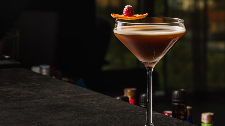 Espresso martini garnished with orange and raspberry