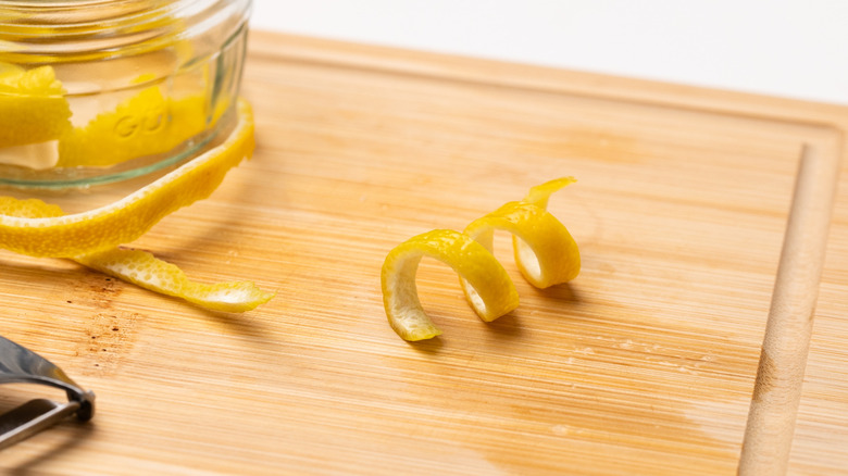 lemon twist on cutting board