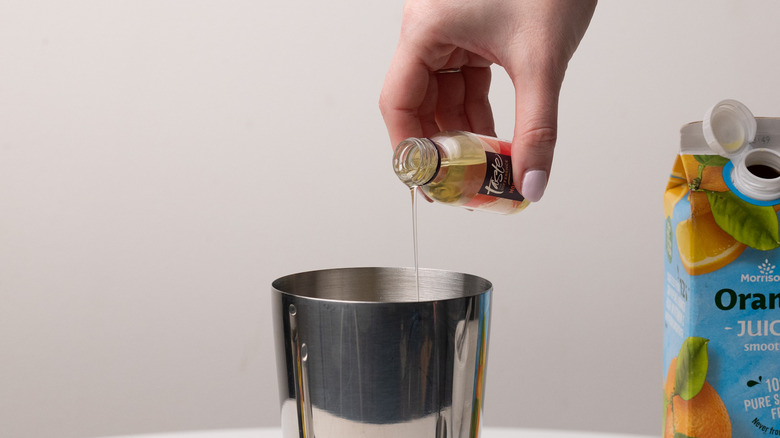 pouring almond extract in shaker