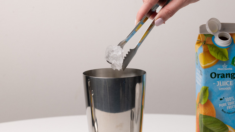 adding ice to cocktail shaker