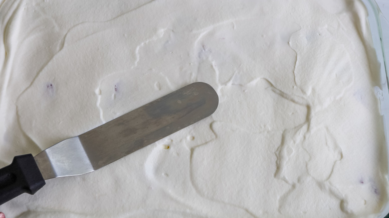 whipped topping being spread in a pan