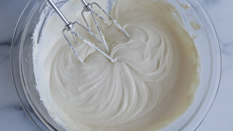 whisking creamy filling in bowl