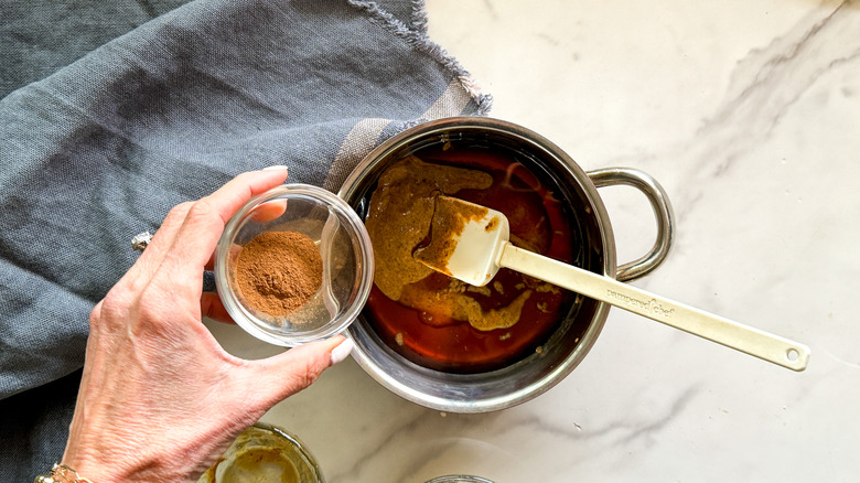 adding cinnamon to pot