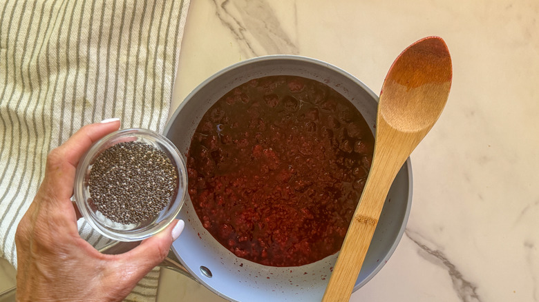 hand adding chia seeds