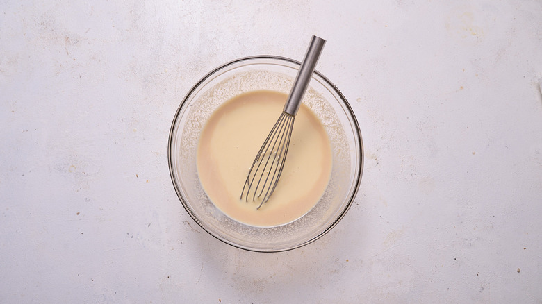 whisking bourbon into condensed milk