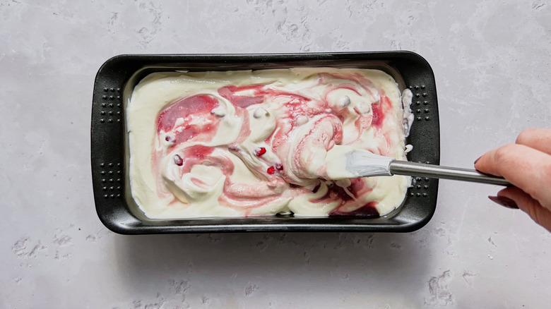 swirling pomegranate into ice cream