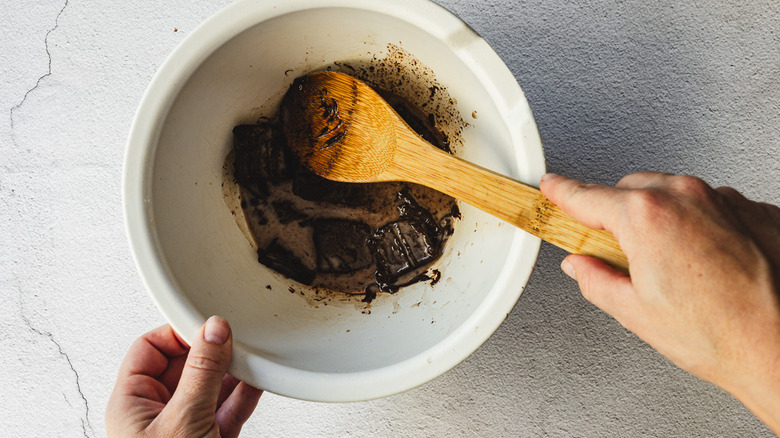 mixing milk and chocolate with spatula