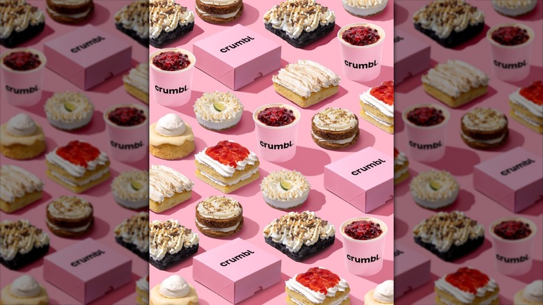 A variety of Crumbl cakes and puddings with the iconic pink boxes