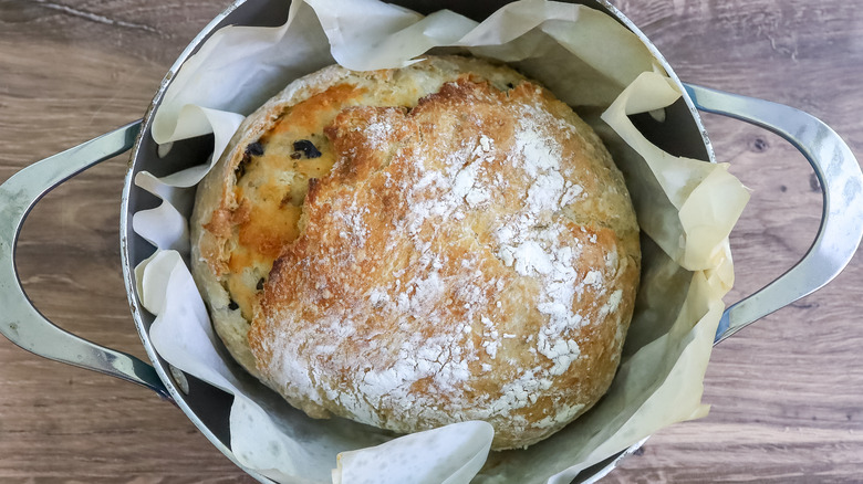 fully baked olive cheese bread in a Dutch oven