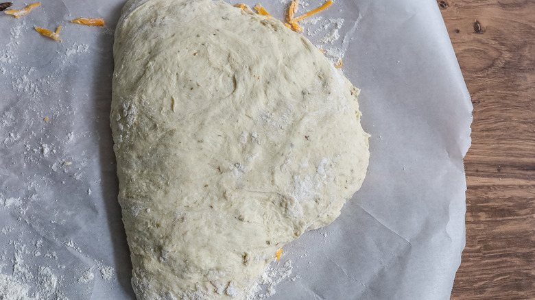 folded dough on parchment paper