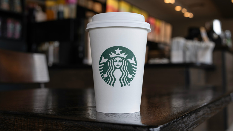 A Starbucks hot cup on a counter