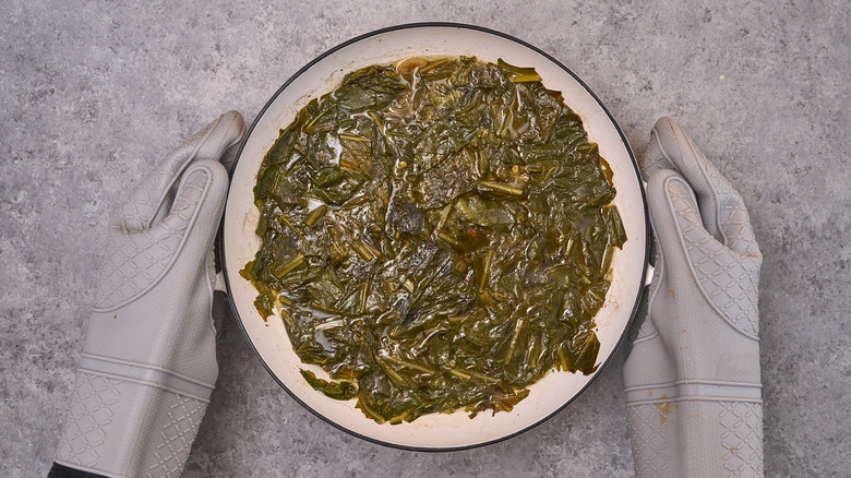 cooked turnip greens with gloves