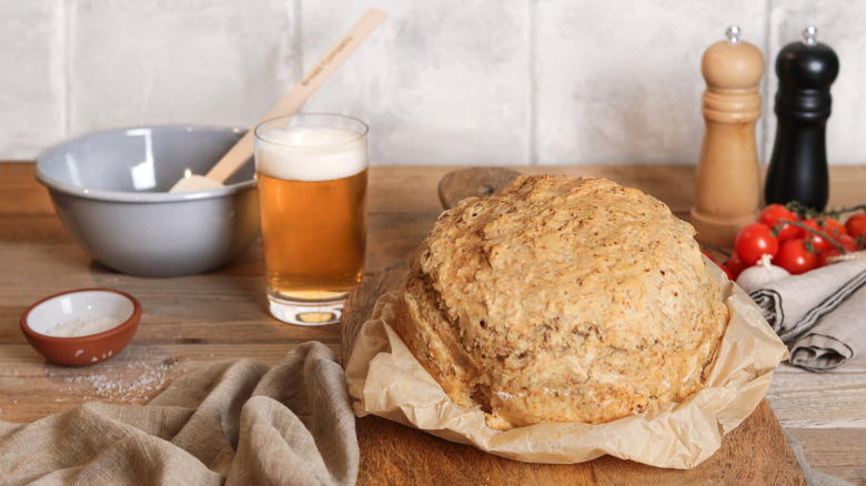 A loaf of beer bread with a glass of beer