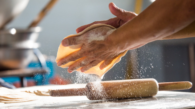 hands making roti chapati bread 