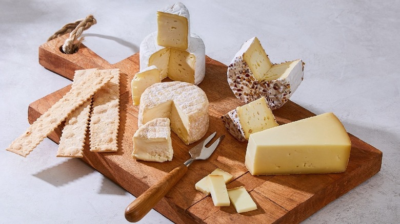 Various cheeses on cutting board