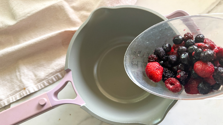 adding berries to pot