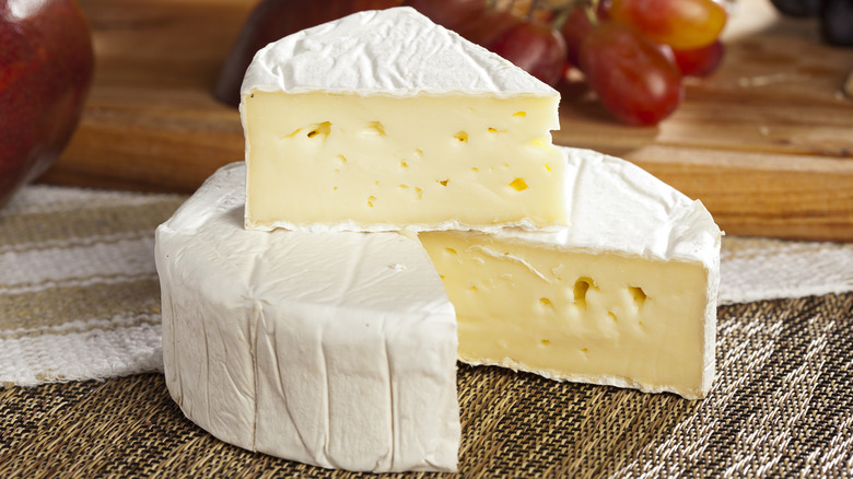 Brie cheese wedges on a tablecloth