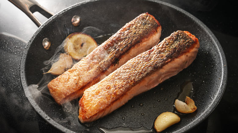 salmon cooking in pan