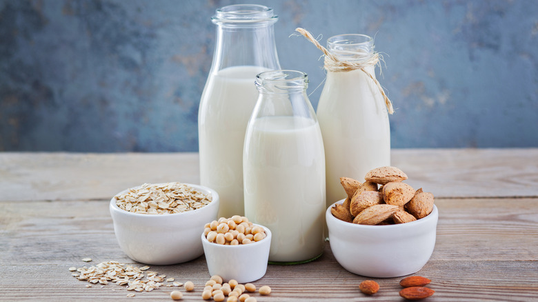 plant milks on wooden table