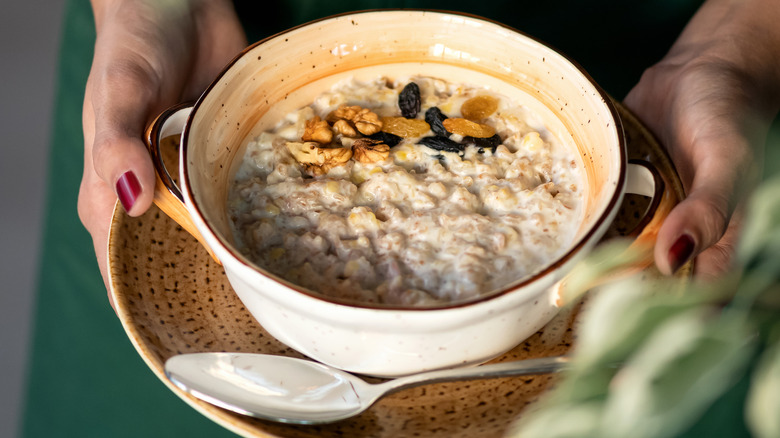 woman holding bowl of oatmeal